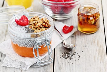 Overnight chia seeds pudding with pumpkin puree in glass jar. Healthy breakfast to go. Superfoods concept