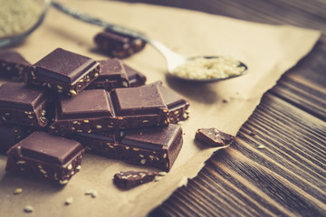 chocolate pieces with sesame on a rustic table
