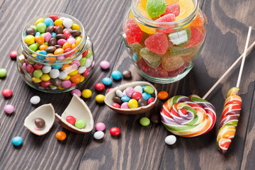 Colorful candies on wooden table
