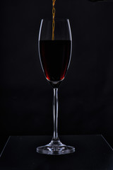 Glass with a long leg on a black background