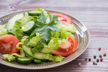 Lettuce, tomato, cucumber, avocado salad for lunch.