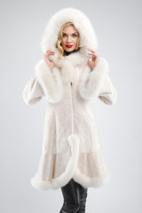 attractive lady in white fur coat with hood on head