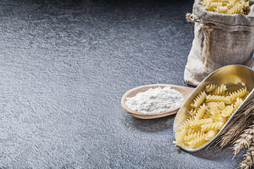 Burlap sack uncooked pasta kitchen scoop wooden spoon flour whea