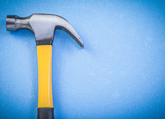 Claw hammer on blue background horizontal view construction conc