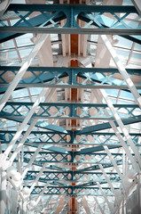 Glass ceiling footbridge with metal structures and circular lamps. Vintage tinted.