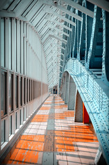 Indoor pedestrian bridge. Glass windows stretching into the distance. Perspective. A lot of repetitive elements. Pedestrian zone.Vintage tinted.