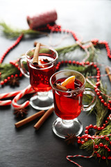 Mulled wine in glass on black wooden table