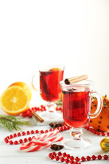 Mulled wine in glass on white wooden table