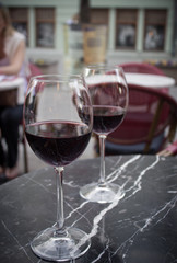two glasses of red wine on the table of summer cafe