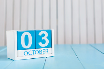 October 3rd. Image of October 3 wooden color calendar on white background. Autumn day. Empty space for text