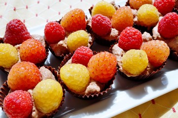 Chocolate tartlet shells filled with aquafaba mousse and raspberries