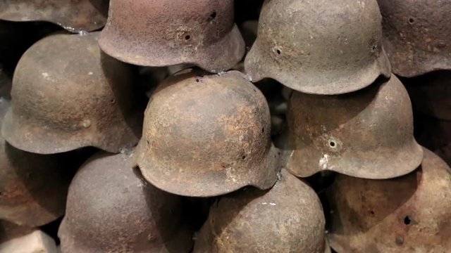 Iron German army helmets of WW2. Rusty nazi army helmets of second world war. German 20th century WWII nazi helmets