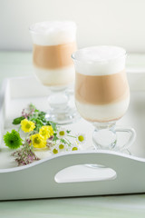 Two latte coffee with spring flowers