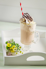 Iced coffee with whipped cream in summer