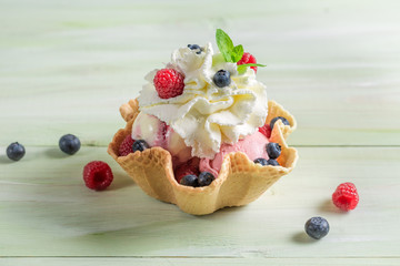 Ice cream with fresh berry fruits and whipped cream