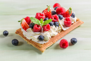 Closeup of waffle with berry fruits and whipped cream - obrazy, fototapety, plakaty