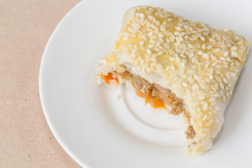 Pie stuffed special pork on white disk for breakfast.