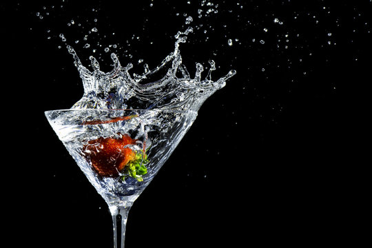 Strawberry Plunging Into A Martini Glass, Making A Splash