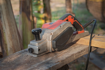 Old electric plane on a board of wood