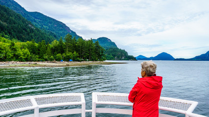 Woman enjoying the View of Howe Sound with its surrounding mountains near the town of Squamish British Columbia