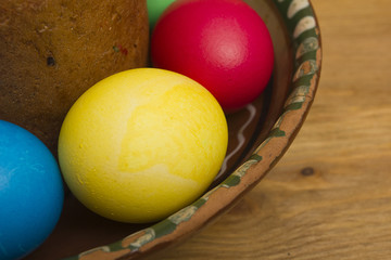 Easter eggs of different colors and cake