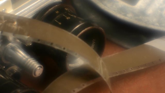 Close-up reel of film and vintage camera with two lenses. blur effect retro camera