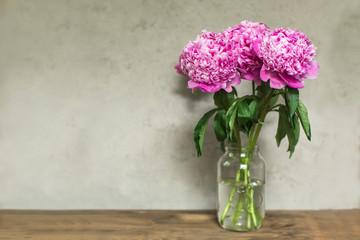 lush pink peonies in vase