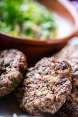 Burgers. Grill burgers. Minced burgers. Roasted burgers with grilled vegetable and herb decoration. Minced meat grilled in a hotel or restaurant.