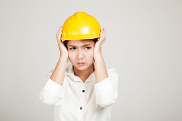 Asian Engineer girl with hard hat got headache