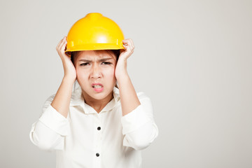 Asian Engineer girl with hard hat got headache