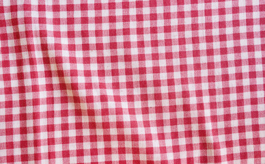 Red crumpled picnic tablecloth background.