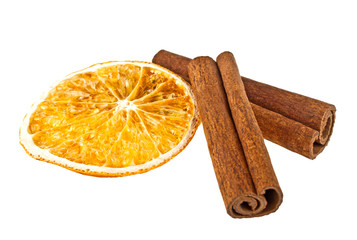 Cinnamon sticks and dried orange slice on a white background