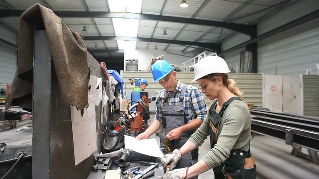 Engineers working in metallurgy warehouse