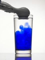 Vibration makes the blue color in water splitting all over the glass. 
