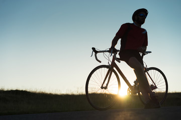 Fototapeta na wymiar cyclist beside his road bike