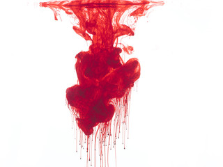 Abstract form of blood or red color in water, isolated on white background.
