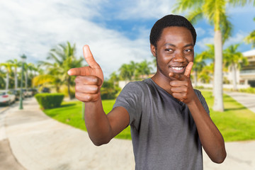 Young african american man pointing copy space
