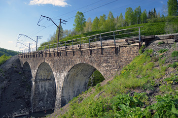 Fototapeta na wymiar Каменный железнодорожный мост через реку