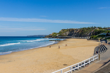 Newcastle Beach with cliffs in the background
