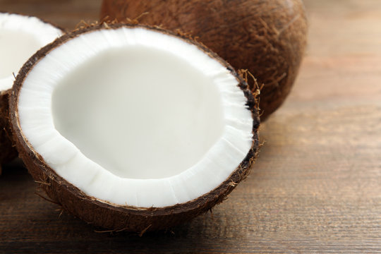 coconut cut into pieces on a brown wooden background