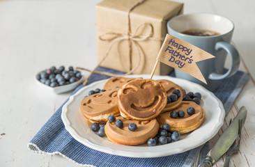 Fathers day concept - pancakes with blueberries and gift