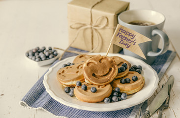 Fathers day concept - pancakes with blueberries and gift