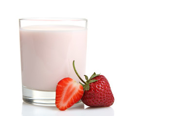 ripe delicious strawberries near the glass Cup with yogurt on white isolated background