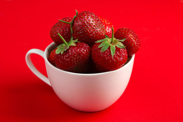 appetizing strawberry in the Cup on red background