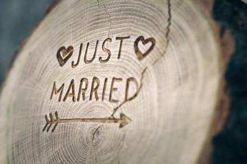 Woodcarving. Newlyweds, Just married, inscription on the wedding