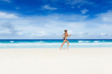 Woman runs on the beach