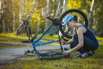 woman repair her bicycle - Powered by Adobe