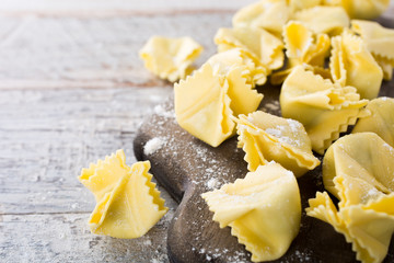 Homemade raw Italian saccottini with green pesto