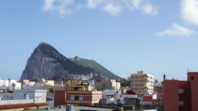 Time lapse of the Rock of Gibraltar and La Linea de la Concepcion cityscape during spring day.