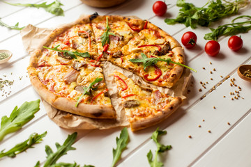 delicious meat pizza with arugula and cherry tomatoes. top view